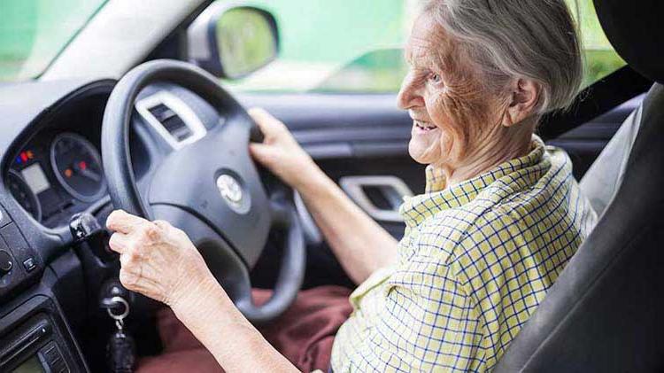 A senior citizen at the wheel of a car