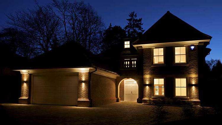 A house at night with a home security system turned on.