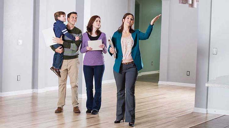 A Realtor showing a home to a young family