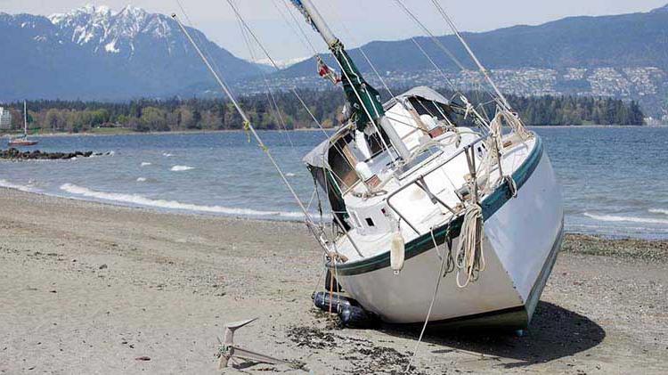 Boat shipwrecked on beach.