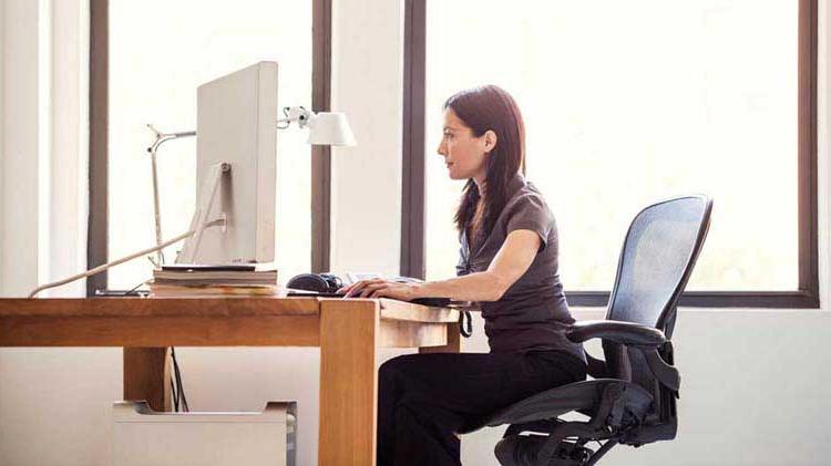 Woman sitting at desk typing