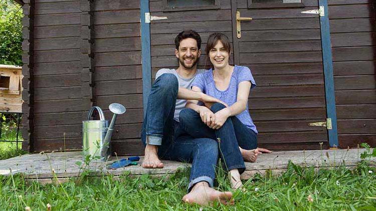 Young barefoot couple in backyard