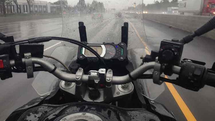 Motorcycle being ridden in the rain.