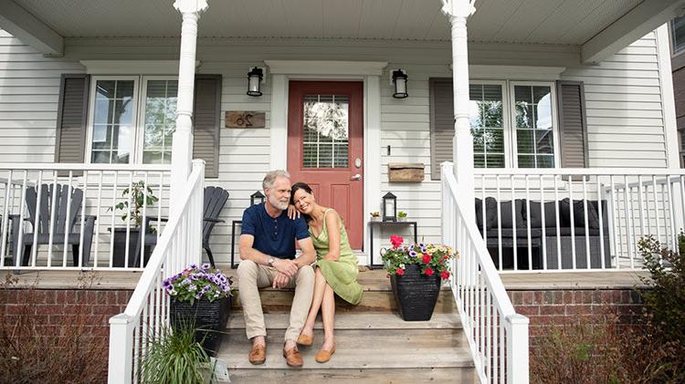 Couple on steps discussing paying off mortgage