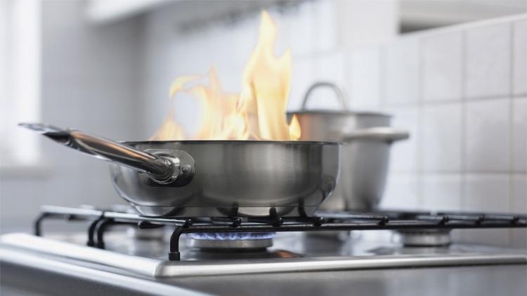 Food burning in a pan on stove.