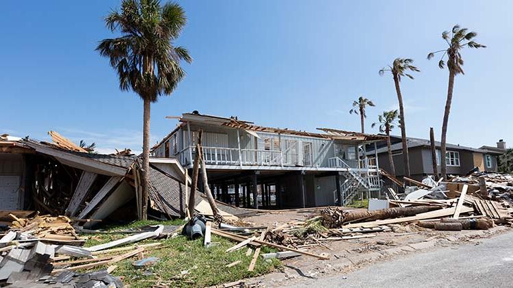 Storm damage to a house and surrounding buildings.