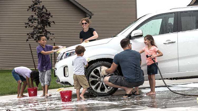 Family washing their car together