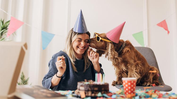 Woman celebrating her dog's Gotcha Day with her furry friend at home.