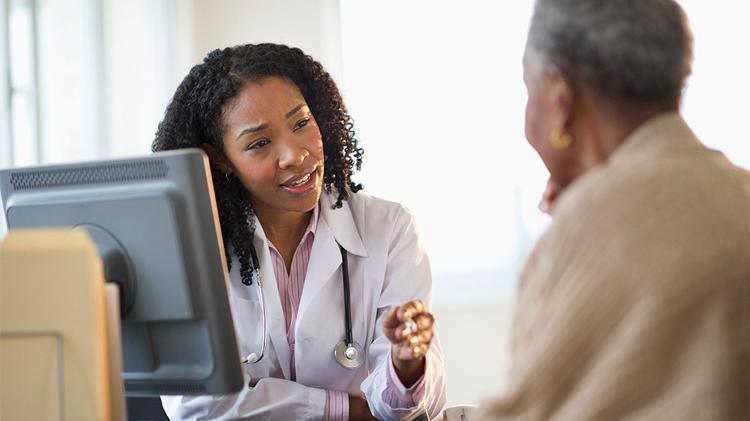 Medical professional offering insights to a patient who has health insurance.